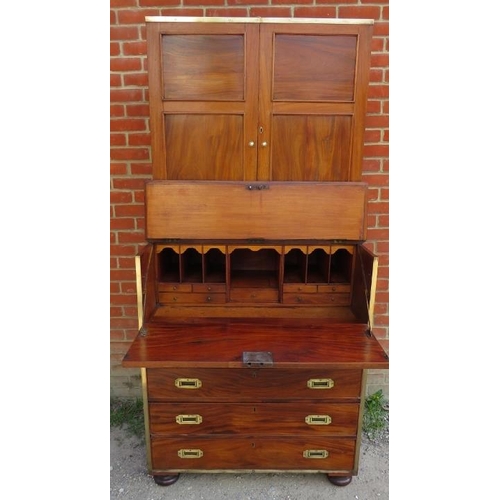 722 - A 19th century camphorwood campaign secretaire bookcase with brass mounts, the bookcase with two hei... 