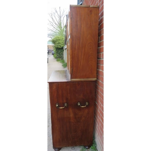 722 - A 19th century camphorwood campaign secretaire bookcase with brass mounts, the bookcase with two hei... 