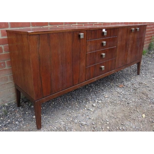 726 - A mid-century Danish tropical hardwood sideboard with sycamore lined interior, housing four short, g... 