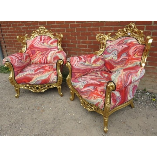 729 - A pair of very ornate giltwood armchairs, the frames carved and pierced in the Rococo style, upholst... 