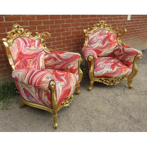 729 - A pair of very ornate giltwood armchairs, the frames carved and pierced in the Rococo style, upholst... 