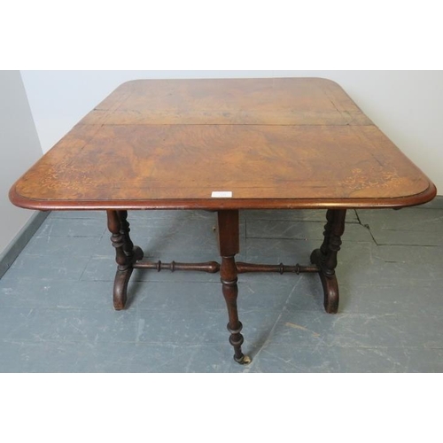 731 - A Victorian walnut Sutherland table, with marquetry inlay, on turned supports with ceramic castors. ... 