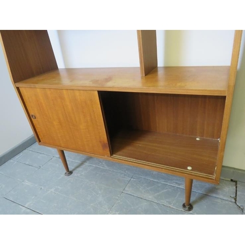 735 - A mid-century teak wall unit with display shelving over a base cupboard, on turned tapering supports... 