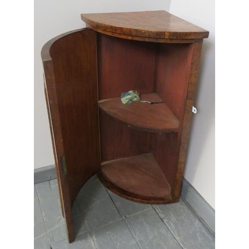 740 - A Victorian burr walnut bow fronted wall hanging corner cupboard featuring marquetry inlay, with fit... 