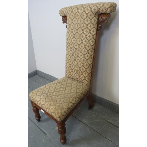 741 - A Victorian walnut prie dieu upholstered in a patterned brocade material, on tapering octagonal supp... 