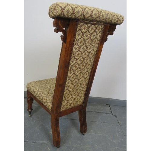 741 - A Victorian walnut prie dieu upholstered in a patterned brocade material, on tapering octagonal supp... 