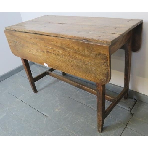 753 - A Georgian elm country made Pembroke table of great character, on tapering square supports with an ‘... 