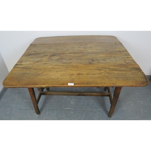 753 - A Georgian elm country made Pembroke table of great character, on tapering square supports with an ‘... 