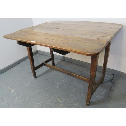 753 - A Georgian elm country made Pembroke table of great character, on tapering square supports with an ‘... 