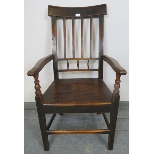 754 - A Georgian oak country made elbow chair with turned spindles, on square supports with stretchers. 
C... 