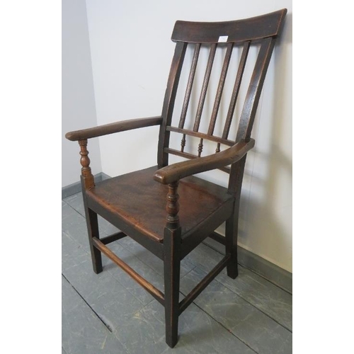 754 - A Georgian oak country made elbow chair with turned spindles, on square supports with stretchers. 
C... 