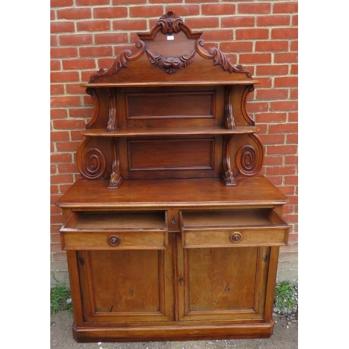 757 - A Victorian walnut chiffonier sideboard with carved and shelved back, housing two short drawers over... 