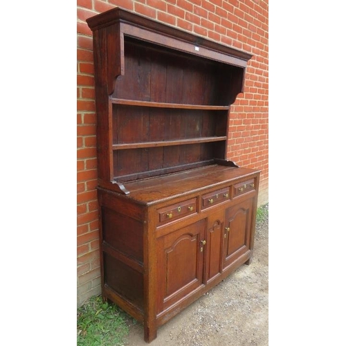 758 - A Georgian oak high back dresser, with plate rack shelving over base containing two short drawers an... 