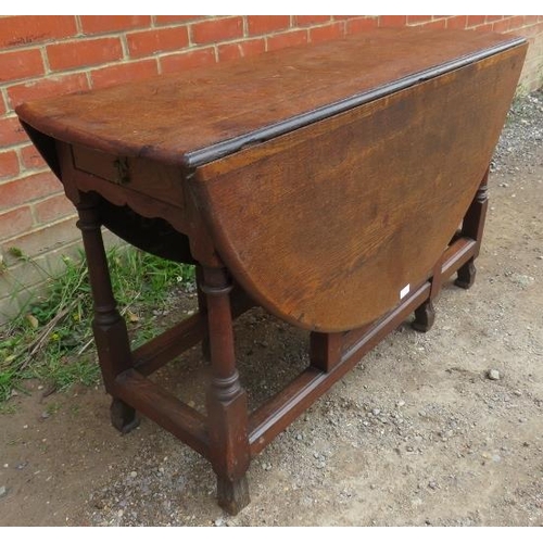 759 - A 19th century oak oval gateleg table with single drawer, on turned and block supports with stretche... 