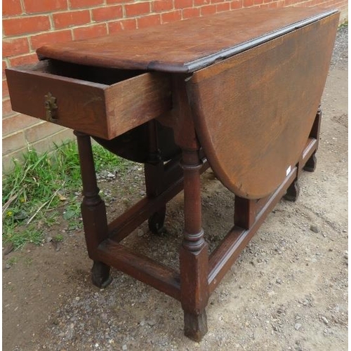 759 - A 19th century oak oval gateleg table with single drawer, on turned and block supports with stretche... 