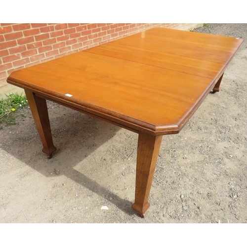 761 - An Arts & Crafts light oak wind-out extending dining table with two additional leaves, on tapering s... 