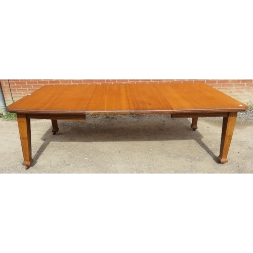 761 - An Arts & Crafts light oak wind-out extending dining table with two additional leaves, on tapering s... 