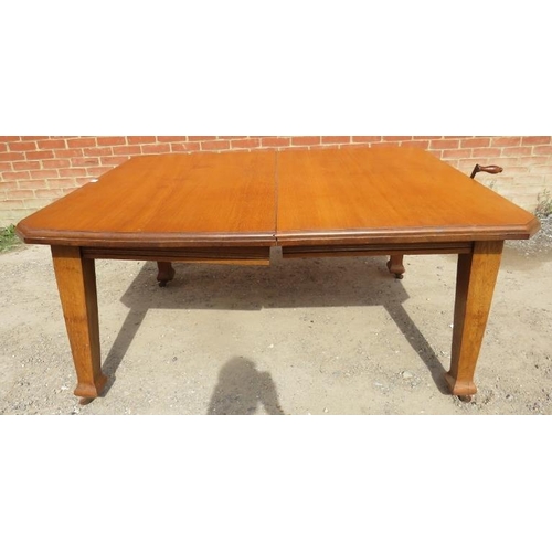 761 - An Arts & Crafts light oak wind-out extending dining table with two additional leaves, on tapering s... 