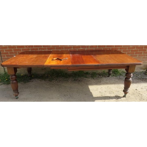 765 - A Victorian mahogany wind-out extending dining table, with two additional leaves, on baluster turned... 