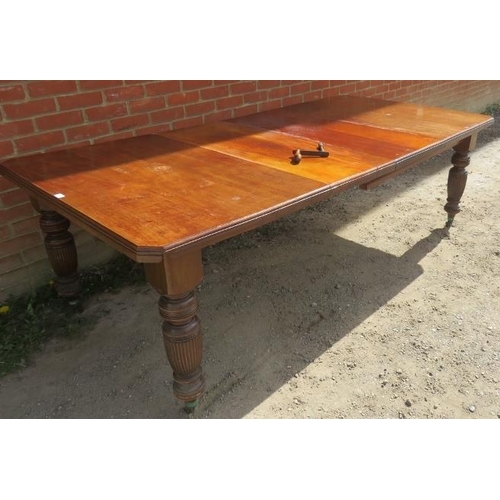 765 - A Victorian mahogany wind-out extending dining table, with two additional leaves, on baluster turned... 