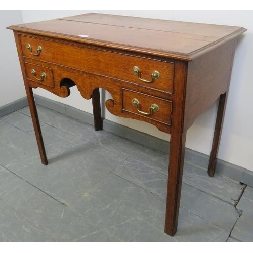 766 - A Georgian oak crossbanded lowboy of good colour, housing one long and two short cock beaded drawers... 