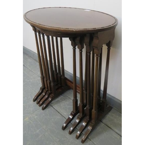 770 - An Edwardian mahogany quartetto of oval nesting tables, with beaded edging, on tapering supports wit... 