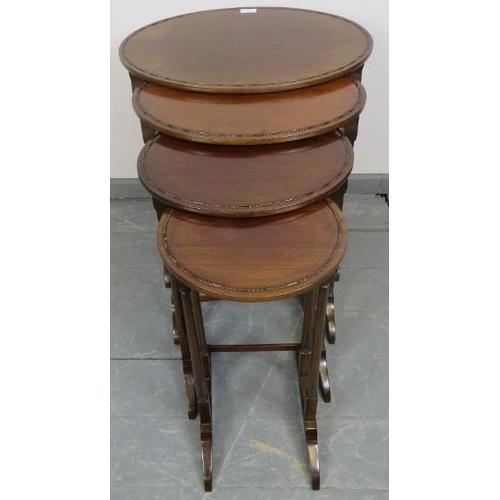 770 - An Edwardian mahogany quartetto of oval nesting tables, with beaded edging, on tapering supports wit... 