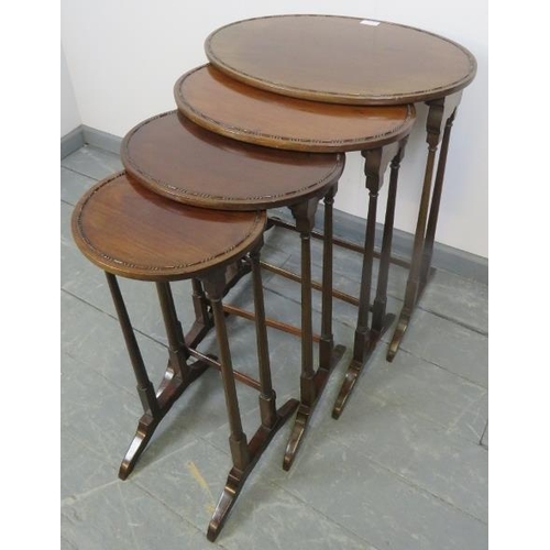 770 - An Edwardian mahogany quartetto of oval nesting tables, with beaded edging, on tapering supports wit... 