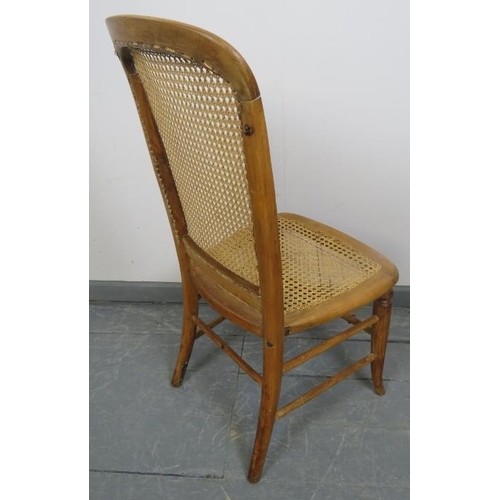 777 - A late 19th/early 20th century fruitwood side chair with bergere seat and back panels, on splayed su... 