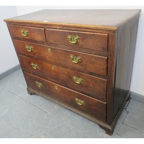 782 - A Georgian oak chest of two short over three long drawers, with brass swan neck handles and lock esc... 