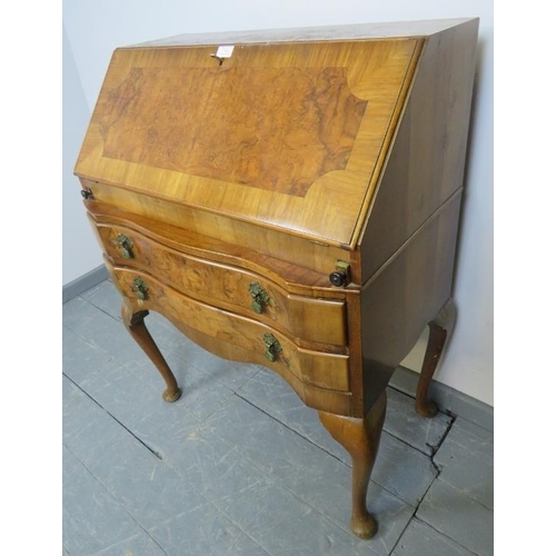 789 - A 1920s burr walnut serpentine fronted bureau, with fitted interior, over two long drawers, on cabri... 