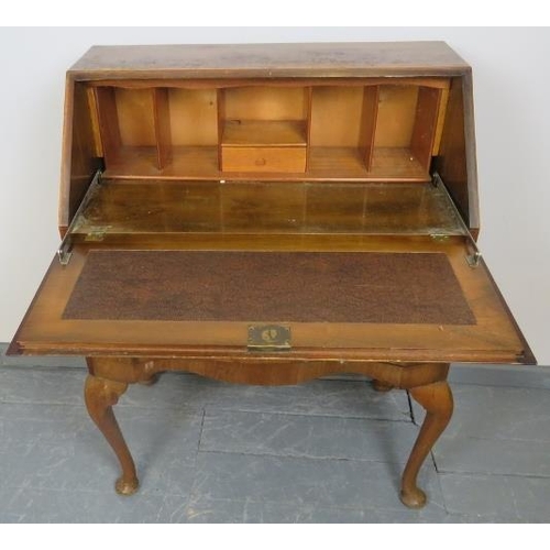789 - A 1920s burr walnut serpentine fronted bureau, with fitted interior, over two long drawers, on cabri... 
