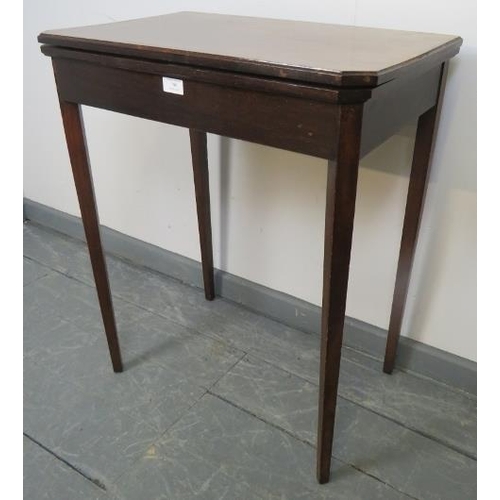 790 - An Edwardian mahogany turnover card table, with inset green baize, on tapering square supports. 
Con... 