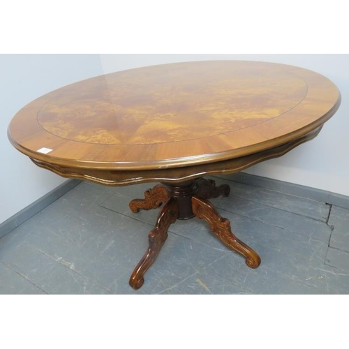 804 - A reproduction 19th century style burr walnut circular breakfast table, the quarter veneered top rai... 