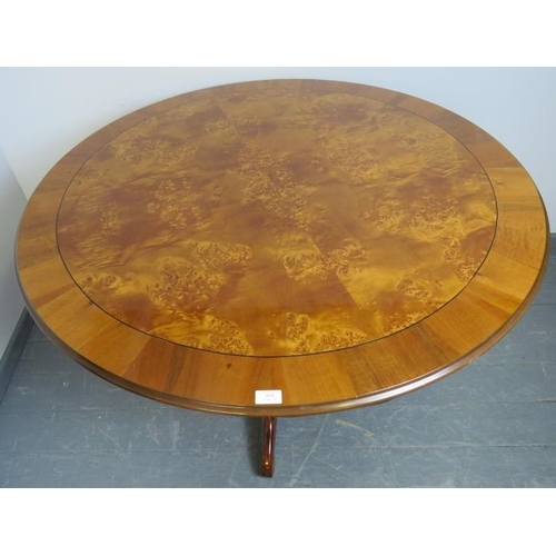 804 - A reproduction 19th century style burr walnut circular breakfast table, the quarter veneered top rai... 