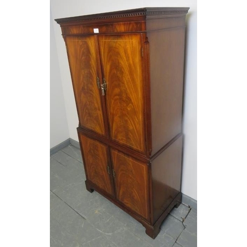 805 - A good quality reproduction flame mahogany drinks cabinet in the Georgian taste, strung with satinwo... 