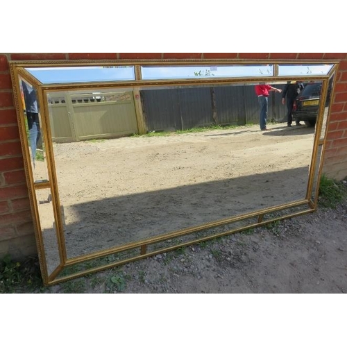 811 - A very large period style gilt framed bevelled rectangular wall mirror, with sectioned mirrored bord... 