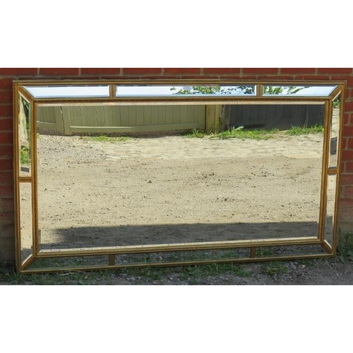 811 - A very large period style gilt framed bevelled rectangular wall mirror, with sectioned mirrored bord... 