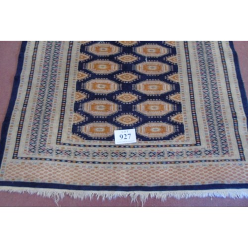 927 - A mid 20's Persian rug. A repeat central pattern orange on black with pale borders. 186cm x 126cm (a... 