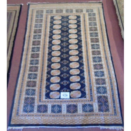 928 - A mid 20's Persian rug.
A repeat central pattern orange/cream on black.  196cm x 125cm (approx).
Con... 