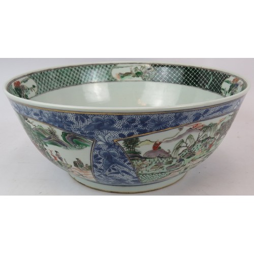 48 - A large Chinese porcelain bowl decorated in the Famille Verte style with enamelled panels depicting ... 