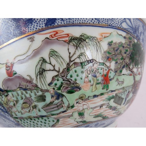 48 - A large Chinese porcelain bowl decorated in the Famille Verte style with enamelled panels depicting ... 