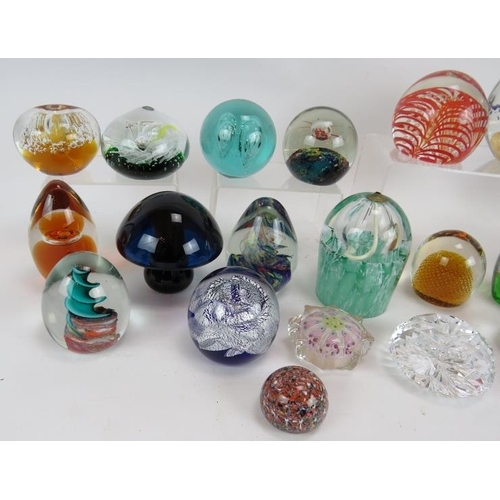 103 - A collection of 28 various paperweights, mostly unsigned but including one Waterford crystal. Larges... 