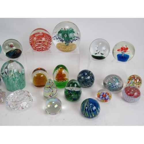 103 - A collection of 28 various paperweights, mostly unsigned but including one Waterford crystal. Larges... 