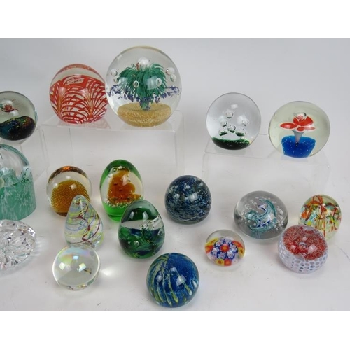 103 - A collection of 28 various paperweights, mostly unsigned but including one Waterford crystal. Larges... 