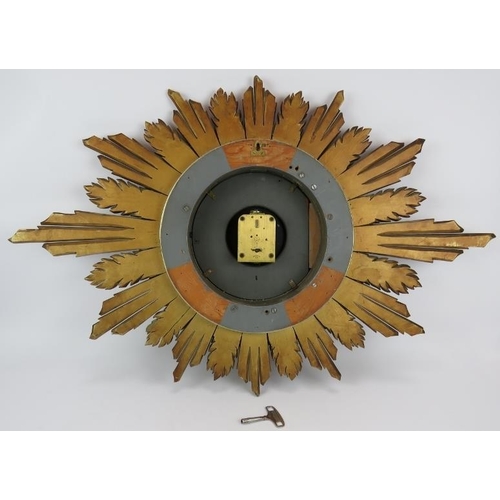 108 - A 1930s carved wood gilt sunburst clock with Astral Coventry fusee movement and key. Width 92cm. Hei... 