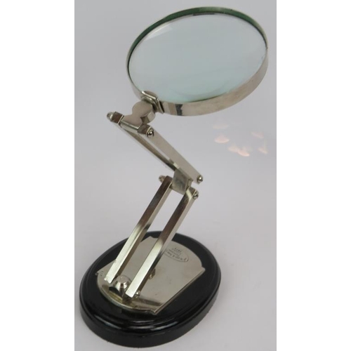 116 - An antique style folding desk magnifying glass labelled for Watts & Sons Ltd Opticians and a cast al... 