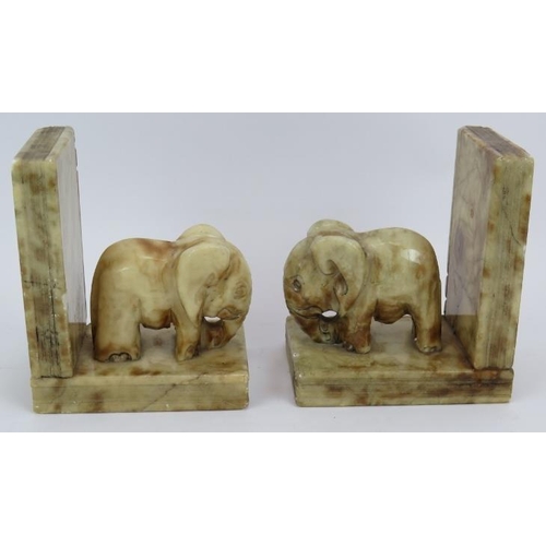 117 - A pair of Art Deco style carved marble elephant book ends each with an elephant mounted on two books... 