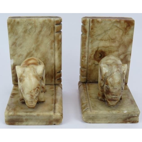 117 - A pair of Art Deco style carved marble elephant book ends each with an elephant mounted on two books... 