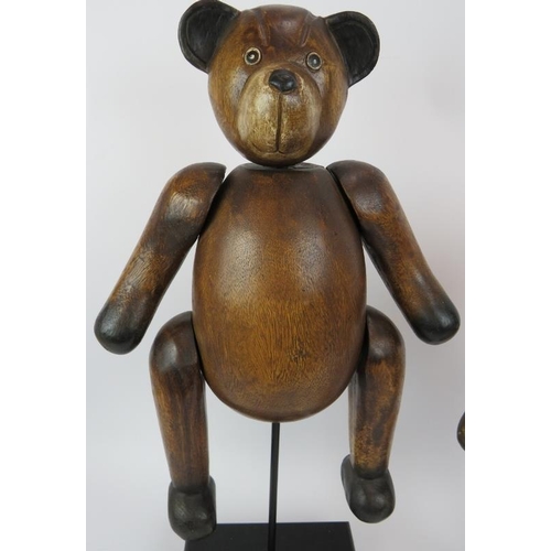 118 - Two carved hardwood jointed teddy bears mounted on black wooden plinths. Tallest 62cm. (2).
Conditio... 